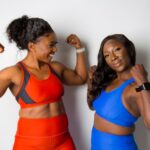 woman in blue sports bra beside woman in blue sports bra